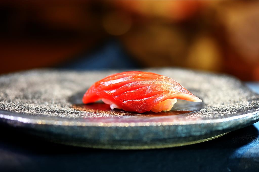 〈鮪魚赤身握壽司〉外層用現刨黃柚子皮屑增添香氣。圖／姚舜